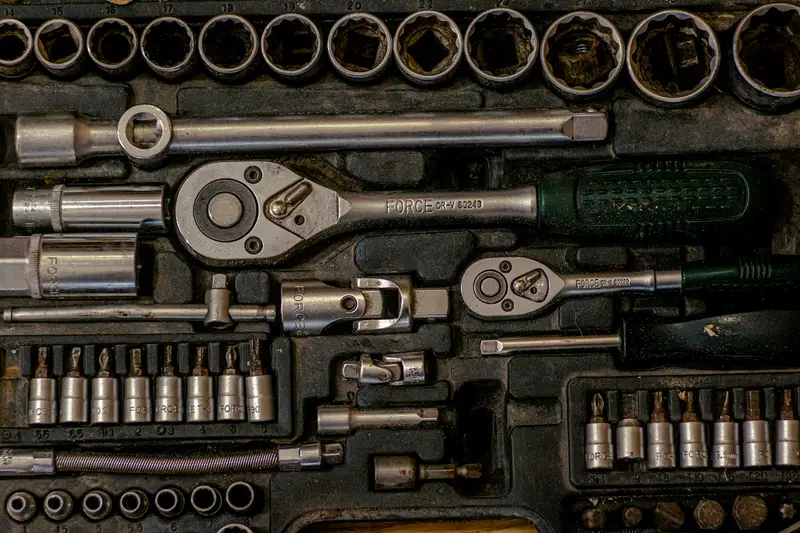 A worn socket set laid out, viewed from above